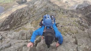 Man scrambling over rocks